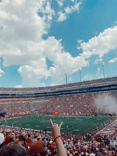 a stadium filled with lots of people watching a football game