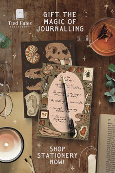 an image of a table with some items on it and the words, gift the magic of journaling