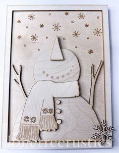 a wooden cutout of a snowman with a hat and scarf