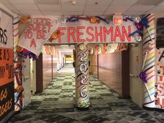 an entrance to a school decorated with colorful ribbons and paper mache letters that read, this sweet to be a freshman