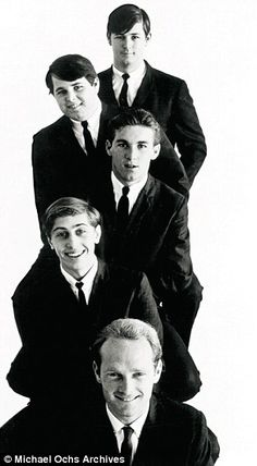 black and white photograph of four men in suits