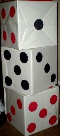 three white boxes with red and black polka dots on them, stacked in the shape of dices