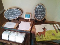 two wooden signs with writing on them sitting on top of a table next to each other