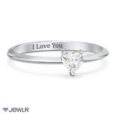 a white gold ring with the words i love you on it and a heart shaped diamond