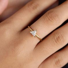 Elevate your everyday look with our 18k Gold Filled Trillion CZ Solitaire Ring. This delicate and gorgeous ring sparkles with a stunning trillion cut CZ stone, adding a touch of elegance to any outfit. The perfect blend of simplicity and luxury, it's a must-have for any stylish fashionista! DETAILS: * 18k gold-filled, Water resistant, CZ Stone MEASUREMENTS: * Size: 5 mm stone CARING TIPS: * Avoid contact with sweat, lotions & perfumes as these can tarnish the jewelry * Keep jewelry clean and dry  * We recommend using polishing cloths to restore the shine to your jewelry OTHER INFORMATION: * All items are packaged in elegant jewelry pouches * Have any questions? Feel free to contact us. We reply fast! MORE FROM US  https://leycorjewelry.etsy.com Instagram: @leycorjewelry Minimalist Crystal Ring With Vs Clarity For Weddings, Trillion Cut Cubic Zirconia Diamond Promise Ring, Minimalist Crystal Wedding Ring With Vs Clarity, Trillion Cut Fine Jewelry For Wedding Gift, Trillion Cut Diamond Ring With Prong Setting As Gift, 14k Gold Trillion Cut Diamond Promise Ring, Dainty Moissanite Diamond Ring For Gift, Trillion Cut Diamond Ring With Vs Clarity For Promise, Trillion Cut Diamond Promise Ring In 14k Gold