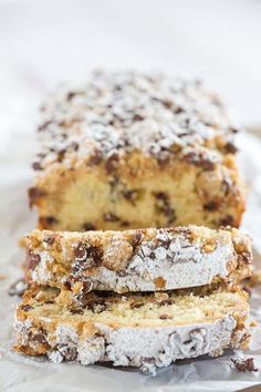 two pieces of cake sitting on top of plastic wrapper covered in powdered sugar