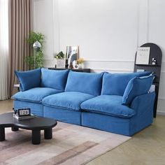 a living room with a blue couch and coffee table