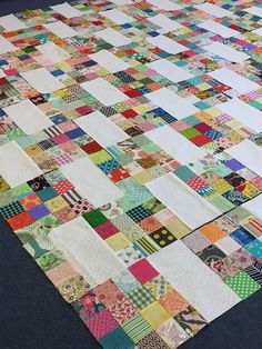 a patchwork quilt is laying on the floor