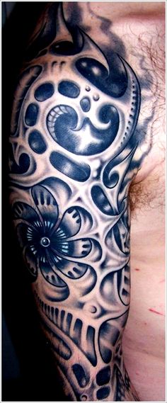 a man with a tattoo on his arm has a skull and flower design on it