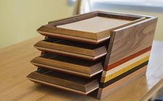 a stack of wooden trays sitting on top of a table