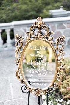 a welcome sign in front of a mirror