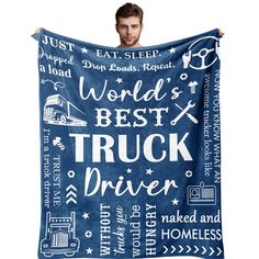 a man holding up a blue blanket that says world's best truck driver