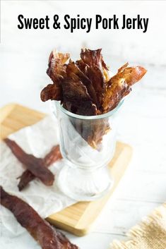 sweet and spicy pork jerks in a glass on a cutting board with the title overlay