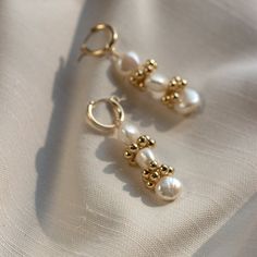 The Baroque Eyelet Mini Hoop Earrings feature a mini hoop that hugs the earlobe and a genuine baroque pearl dangle with gold or silver signature clustering. They are perfect for everyday wear! Lightweight and comfortable to wear. Wear them two ways - slide the dangle off to wear just the simple hoop earring."BAROQUE EYELET MINI HOOP EARRINGS" by GoldenLinings - Christine Elizabeth JewelryD E T A I L S_________________Materials: 14K Gold Fill or Sterling SilverClosure: latch hookS I Z E S________ Elegant Gold Plated Huggie Pearl Earrings, Gold Plated Yellow Gold Huggie Earrings With Pearl Drop, Elegant 14k Gold Filled Huggie Cartilage Earrings, Single 14k Gold Filled Drop Pearl Earring, Delicate Yellow Gold Hoop Pearl Earrings, Pearl Charm Huggie Jewelry For Anniversary, Huggie Pearl Charm Jewelry For Anniversary, Gold Plated Hoop Earrings With Pearl Drop As Gift, Gold Huggie Pearl Earrings For Gift