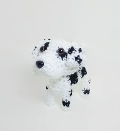 a small crocheted dog is standing on its hind legs and it's eyes are wide open