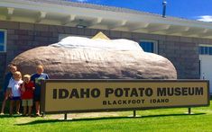 three children standing in front of the idaho potato museum