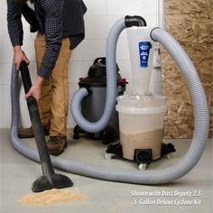 a man is cleaning the floor with a vacuum and duster next to it,