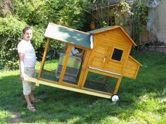 a man standing next to a chicken coop