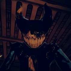 an animated image of a demonic looking man with horns and fangs on his face, standing in front of a building