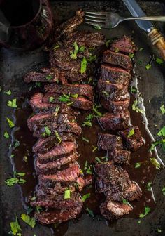 steaks with sauce and parsley on a baking sheet