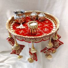 a red table topped with lots of gold decorations