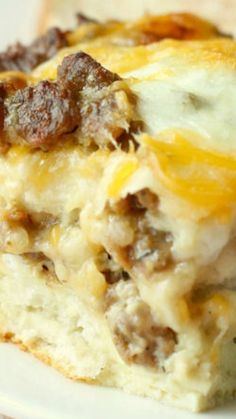 a close up of a plate of food with cheese and sausage on it's side