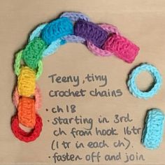 there are crocheted items on the table with words written in them and instructions for how to make them