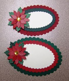 two red and green paper poinsettis sitting next to each other on the floor