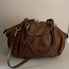 Medium Sized Brown Leather Gucci Bag. It Is Versatile Bag That Can Be Used For Work Or A Casual Night Out. It Has A Zip Closure And One Pocket On The Inside. The Shoulder Straps Are Adjustable. This Bag Had Minimal Use And Was Well Taken Care Of. Gucci Satchel With Detachable Strap For Shopping, Gucci Shoulder Bag With Double Handle And Removable Pouch, Chic Gucci Satchel With Removable Pouch, Designer Gucci Shoulder Satchel, Gucci Satchel With Handle Drop For Shopping, Chic Gucci Bag With Double Handle, Chic Gucci Double Handle Bags, Gucci Handheld Shoulder Bag For Everyday Use, Everyday Handheld Gucci Satchel