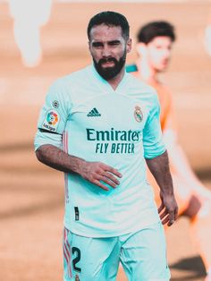 a man with a beard is playing soccer