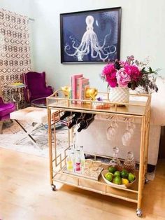 a living room filled with lots of furniture and flowers on top of a wooden table