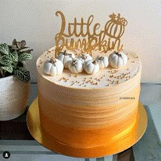 there is a cake with little pumpkins on it