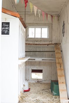 the inside of a building with hay and bunting