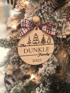 a wooden ornament hanging from the side of a christmas tree that says dunkle family