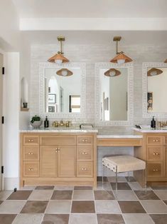 a bathroom with two sinks and three mirrors