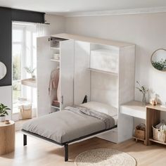 a bedroom with a bed, desk and shelves on the wall next to a window