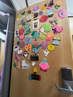 a refrigerator covered in lots of different types of magnets and paper cut out shapes