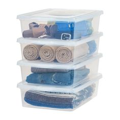 three plastic storage containers stacked on top of each other with towels and blankets in them