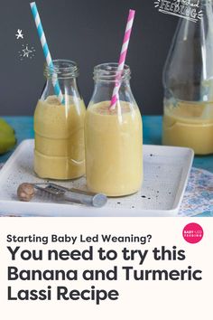 two bottles filled with banana and tumeric lassi next to each other on a tray