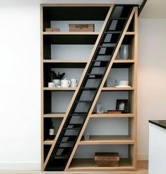 an open bookcase with stairs leading up to the top