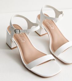 New Look Wide Fit White Low Block Heel Sandals. Summer getaway or special occasion? Wherever you're heading, these white block heel sandals feature new Comfort.  technology that will take you from sunrise to sunset. Wide fit. Extra measure across the insole, joint and instep. Leather-look finish. 2-part design. Open toe. Ankle strap fastening. Low block heel. Heel height: 2.5" / 7cm. Also available in our Core range. Comfort: a range of styles designed with features such as cushioned padding, so White Small Heels, White Low Heels, 3cm Heels, White Summer Shoes, White Block Heel Sandals, White Footwear, Low Block Heel Sandal, White Block Heels, Game Outfit