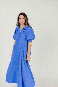 The Karsyn Midi Dress is a summertime must-have! This midi dress offers the comfortable shirt-dress silhouette we all love, but in an elevated design; its puffed short sleeves and darted bodice gives the Karsyn a flattering, feminine fit, while the beautiful textured fabric is lightweight and an eye-catching hue, perfect for all your summer jaunts. FIT: Runs true to size. MATERIAL: Shell: 100% Polyester; Lining: 100% Cotton. Hand wash cold; not not bleach, do not tumble dry. Iron low. GARMENT DE Short Sleeve Dresses With Gathered Sleeves For Brunch, Brunch Dresses With Gathered Short Sleeves, Spring Daywear Relaxed Fit Puff Sleeve Dress, Spring Daywear Puff Sleeve Dress With Relaxed Fit, Spring Puff Sleeve Relaxed Fit Dress For Daywear, Spring Relaxed Fit Puff Sleeve Dress For Daywear, Casual Short Sleeve Maxi Dress With Gathered Sleeves, Summer Short Sleeve Shirt Dress For Spring, Short Sleeve Shirt Dress For Spring