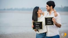 a man and woman holding signs that say save the date