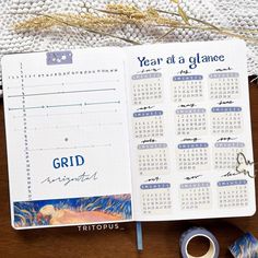 an open planner sitting on top of a wooden table