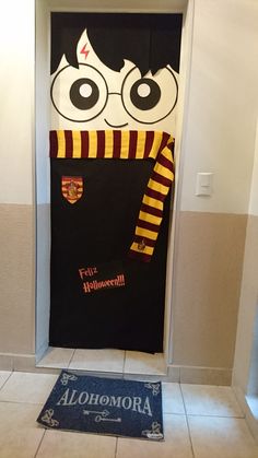 a harry potter door cover with the hogwarts crest on it and an alohomaria mat