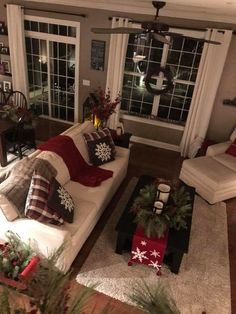 the living room is decorated for christmas with red, white and green decorations on the couches