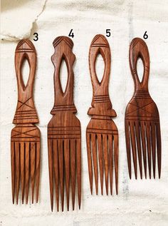 Natural wood combs hand carved by artisans in Africa. Made in Senegal. Size varies 10-12”L x 2.5”W Sold individually, not a set. African Comb, African Decor Living Room, Afro Comb, Afro Pick, African Crafts, African Home Decor, Insta Profile, Ceramic Hair, Fabric Ideas