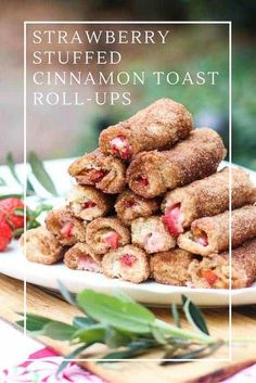 strawberry stuffed cinnamon toast roll ups on a white plate