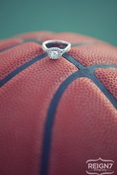 a diamond ring sitting on top of a basketball