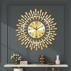 a clock that is on the side of a wall next to a table with vases